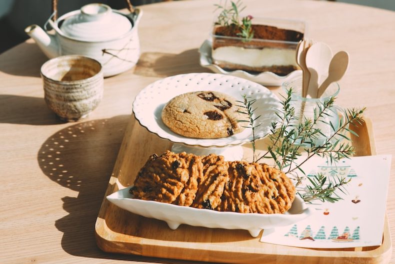 a wooden table topped with a plate of food